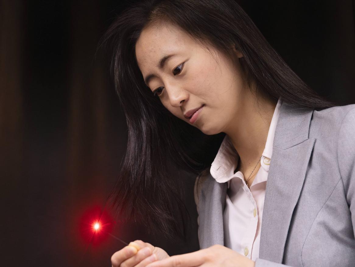 Dr Jiawen Li holding a sensor
