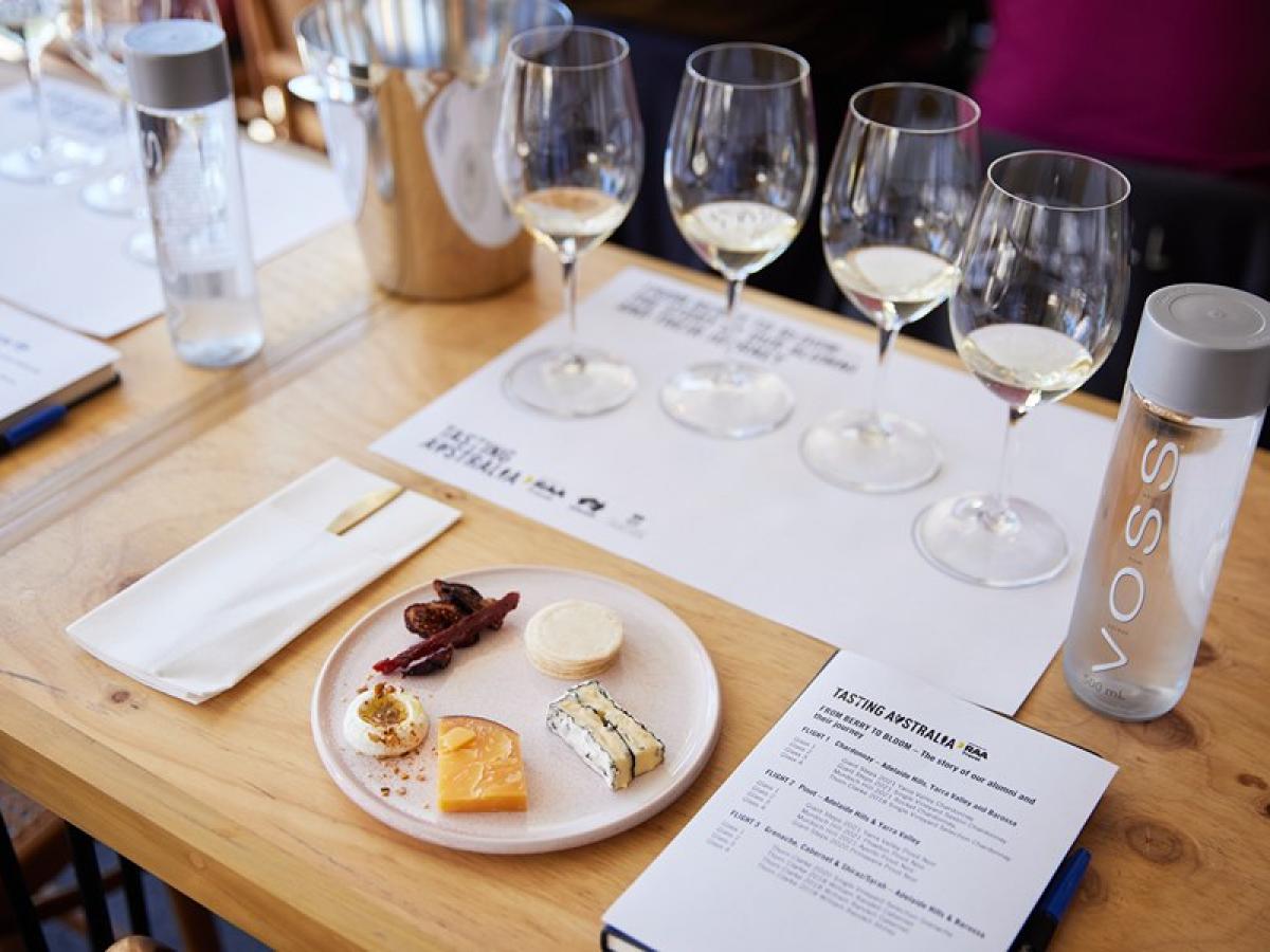 A cheese tasting plate accompanied by wines