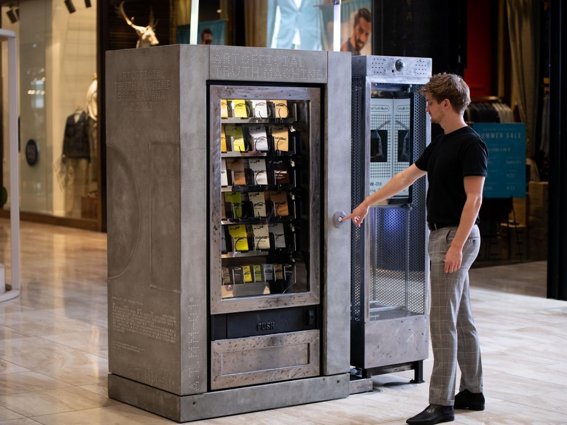 A man presses a button on the AI Vending Machine