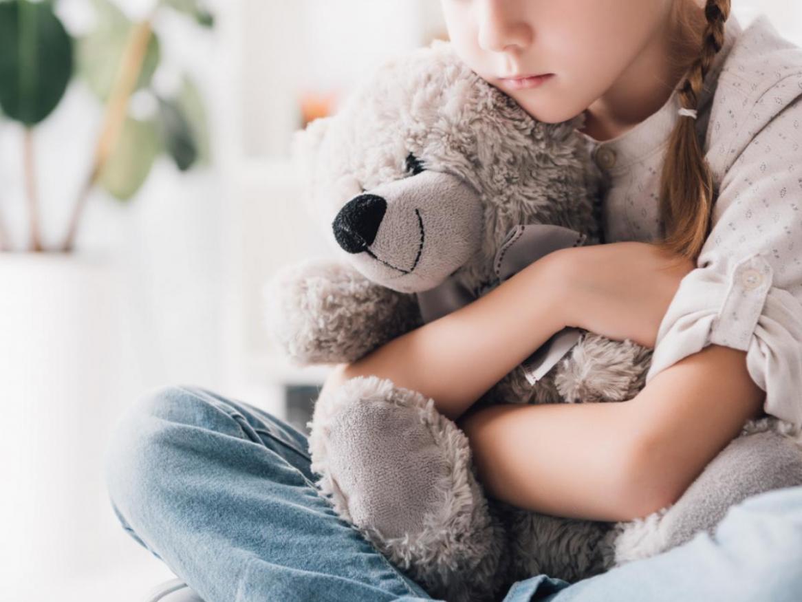 child holding teddy bear 