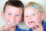 Students from Nailsworth Primary School, Sam, 8, and Sophie, 5, swabbing the inside of their cheeks for the cerebral palsy research. Nailsworth Primary is the first school to be visited by the researchers to recruit students and their mothers for the study.
Photo by Michael Marschall, courtesy of <i>The Advertiser</i>