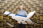 Professor Colin Hansen with a model aircraft in the School of Mechanical Engineerings anechoic chamber
Photo by Chris Tonkin