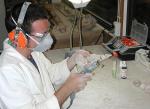 Dr Ben Kear working on an opalised plesiosaur
Photo courtesy of the South Australian Museum