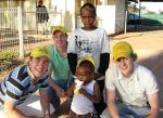 Third-year medical student Sam McGinness, third-year architecture student Ed Mitchell and first-year architecture student Nelson Lee talk to local Davenport children