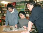 Catching up on news in the South China Morning Post in the new International Lounge are Hong Kong students (from left) Tom Li, Kei Fung Yeung and Evelyn Lo.