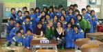 Adelle Neary (front centre, in green) makes some new friends in a Japanese classroom
Photo courtesy of Adelle Neary