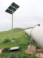 A chlorine monitoring site on the Myponga trunk main at Cactus Canyon. The small copper pipe feeds water to the chlorine monitor in the black box, powered by the solar panel in the background
Photo by Stan Woithe