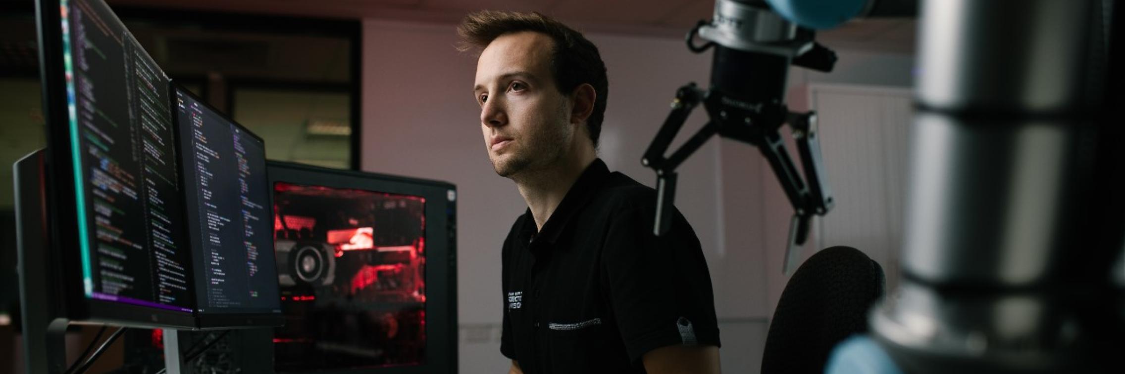 AIML research programmer Thomas Rowntree working at a computer