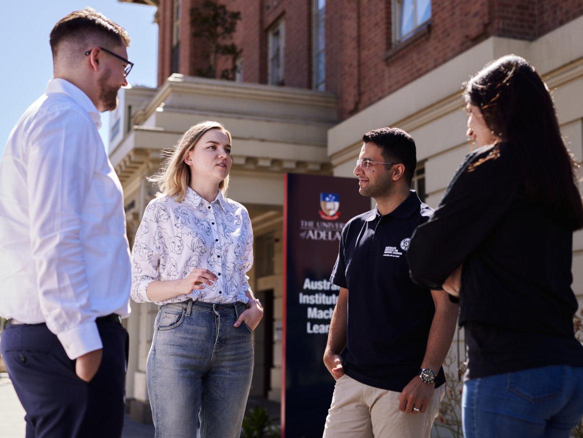 group of people talking outside the AIML building in Adelaide