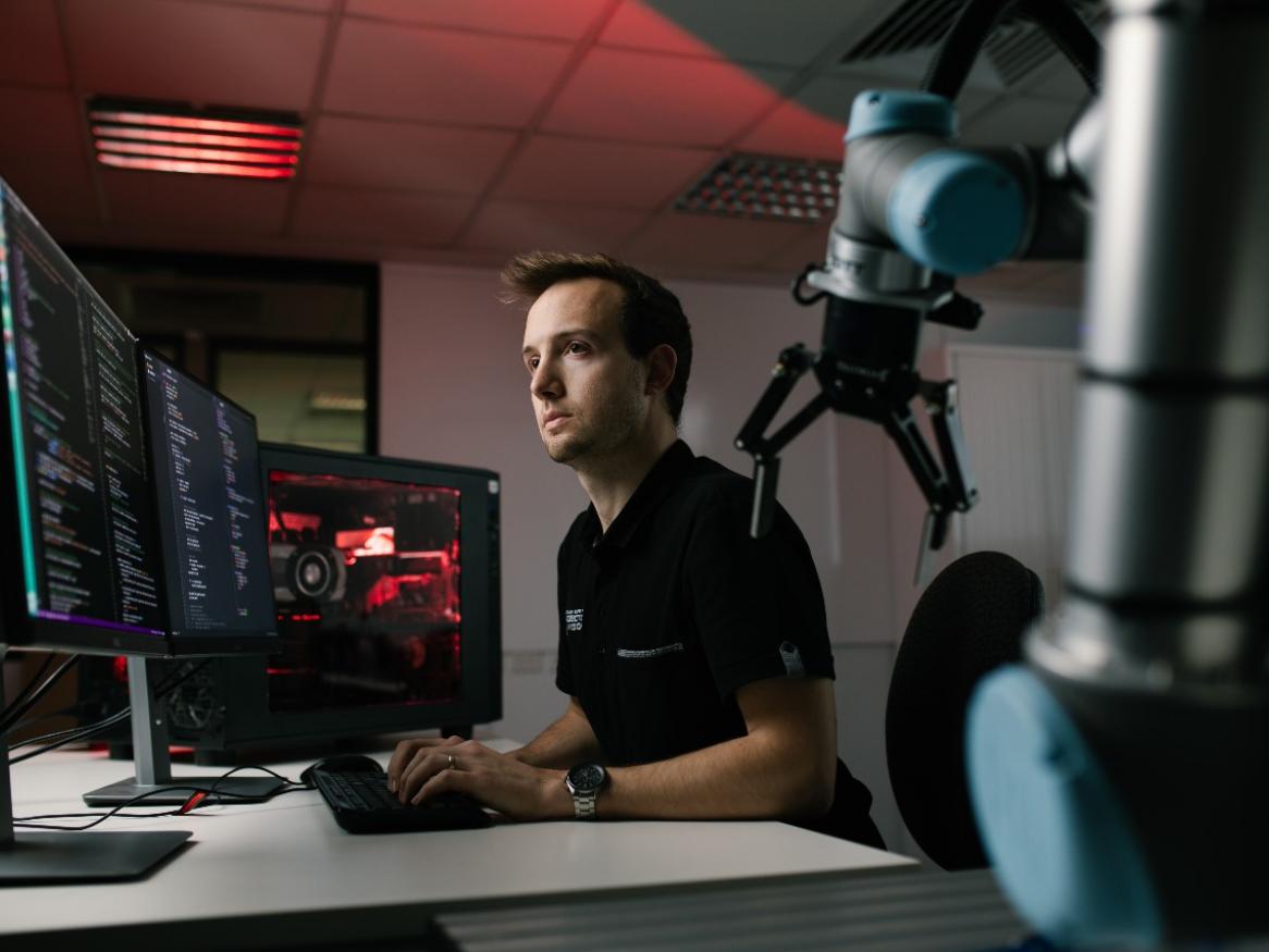 AIML research programmer Thomas Rowntree working at a computer