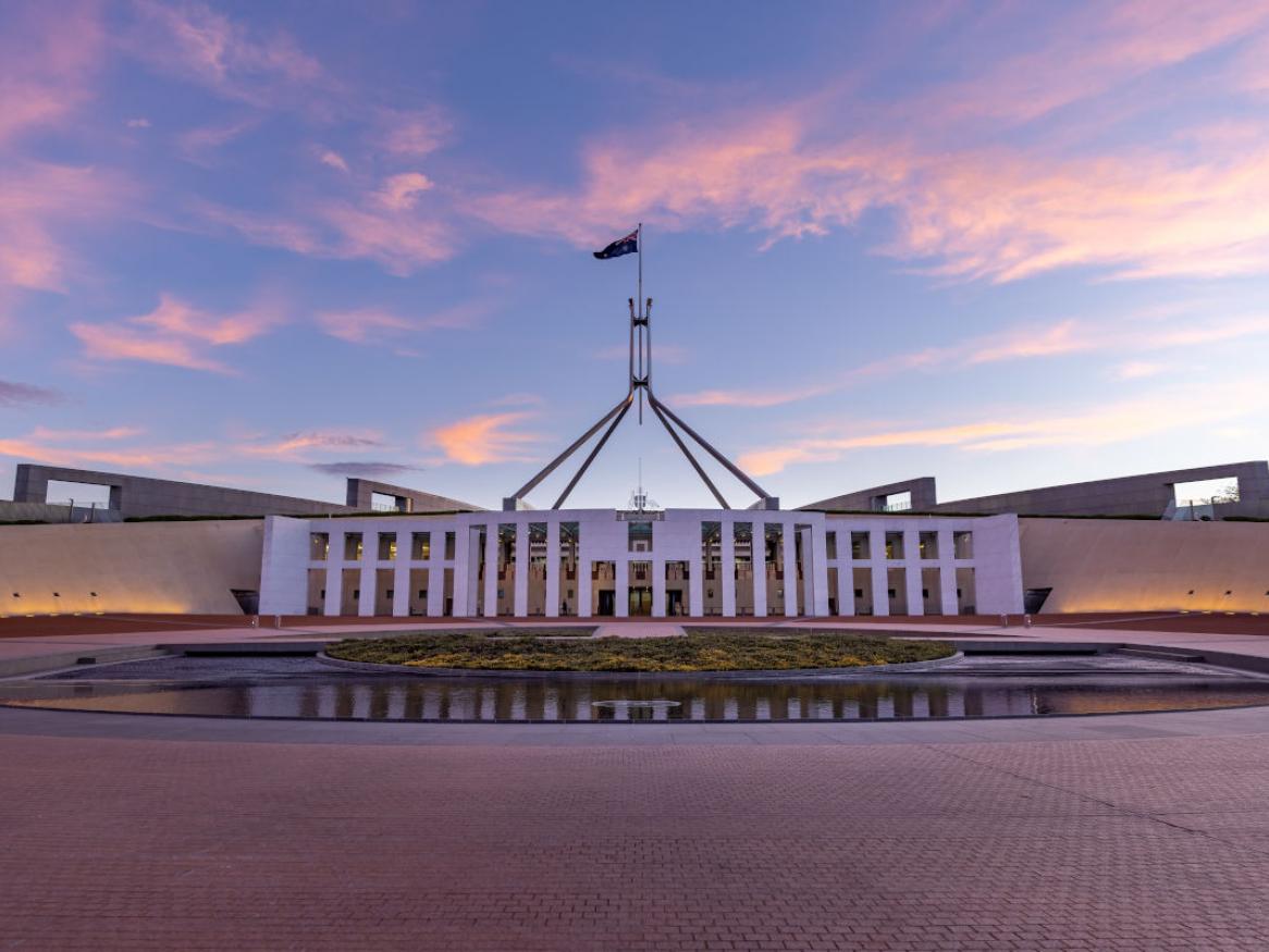 front facade of Australian parliament house in Canberra at dawn