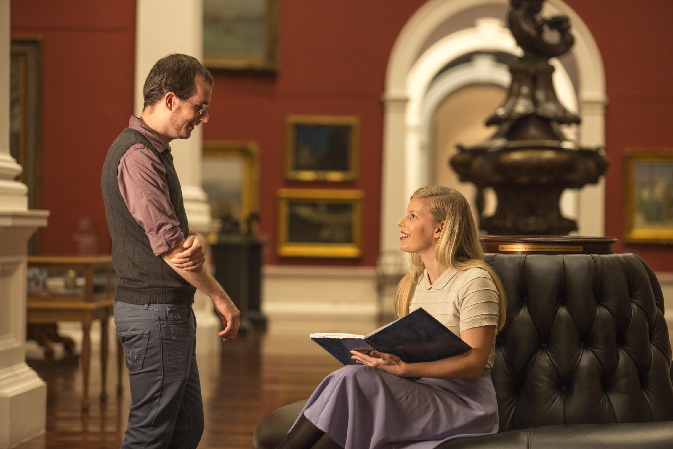 People talking in a museum