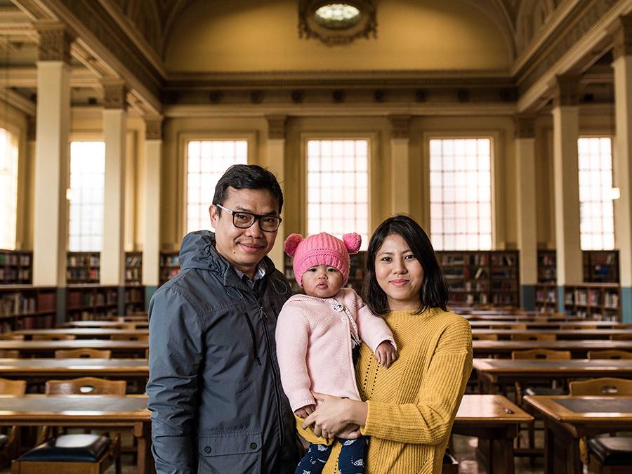Rupananda Roy with partner and baby in the Barr Smith Library