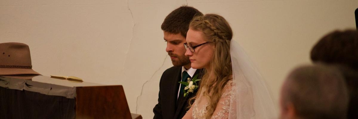 David and Elsabeth playing a piano at their wedding