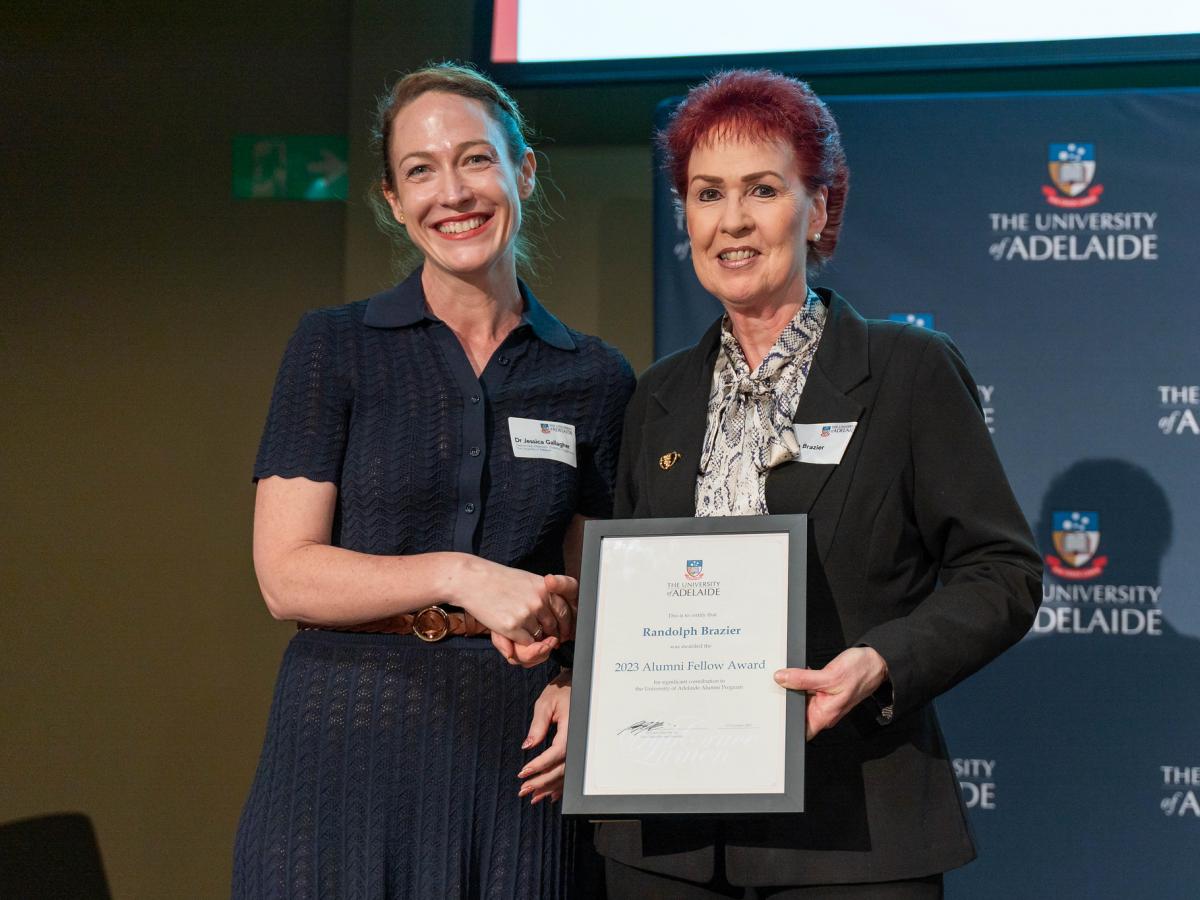 Lynn Brazier accepts Randolf Brazier's Alumni Fellow award from Prof Jess Gallagher