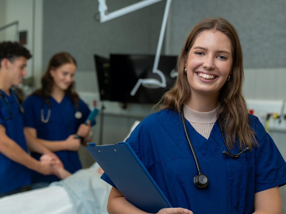 A photo of Agnes in scrubs in a medical room