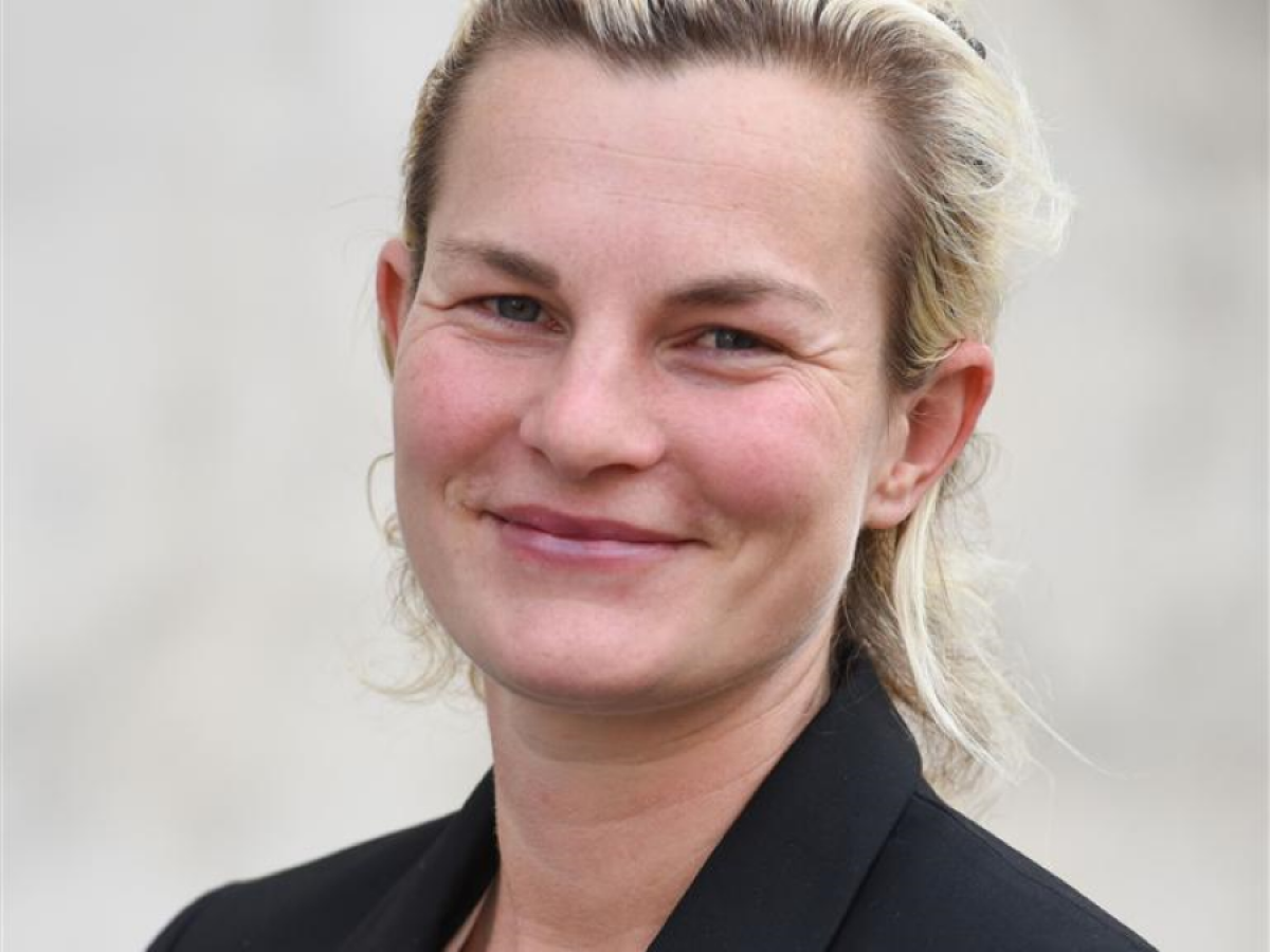 A portrait of Dr Moulds smiling, wearing a black blazer