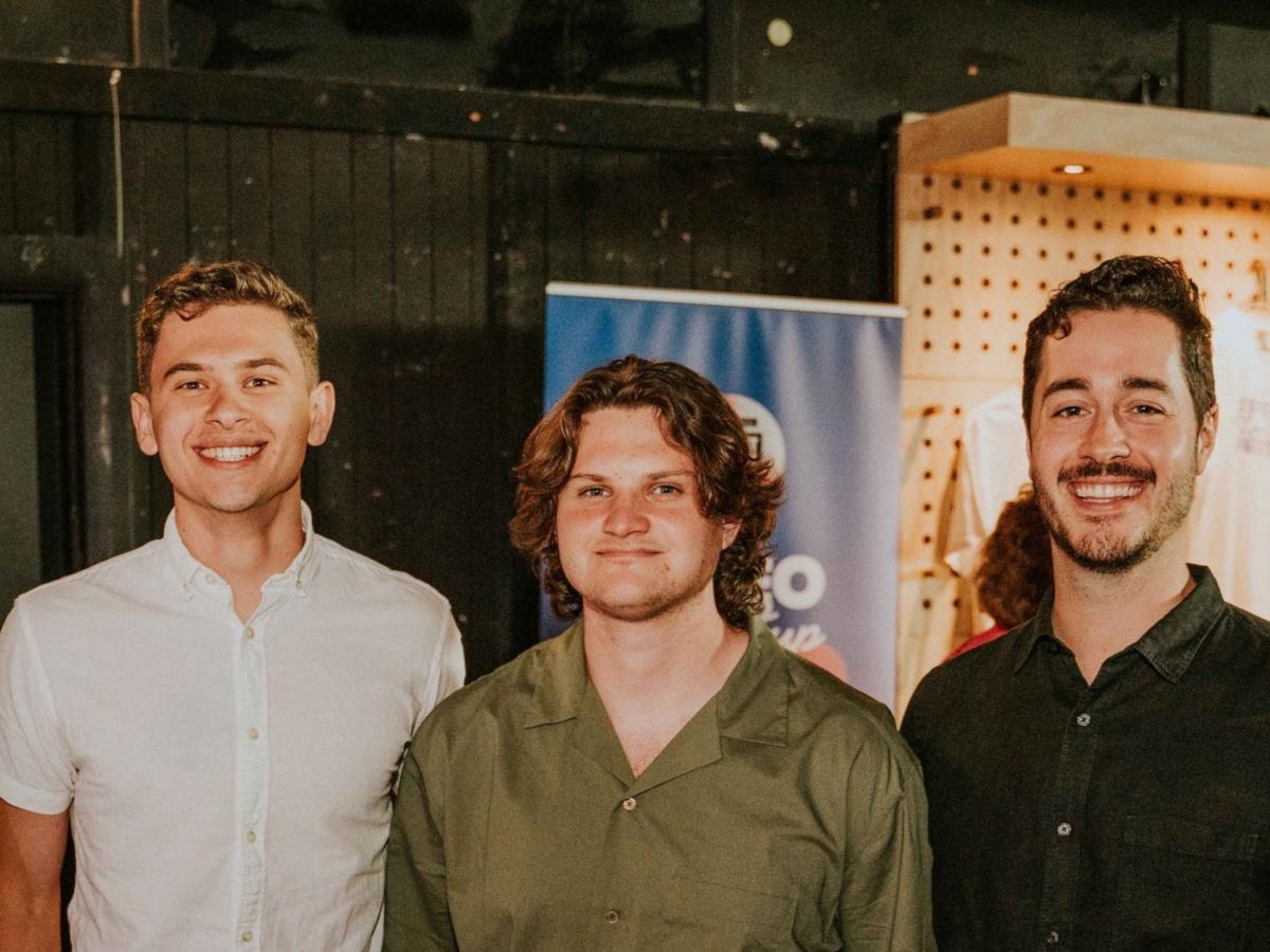 A group photo of Harry and two other students