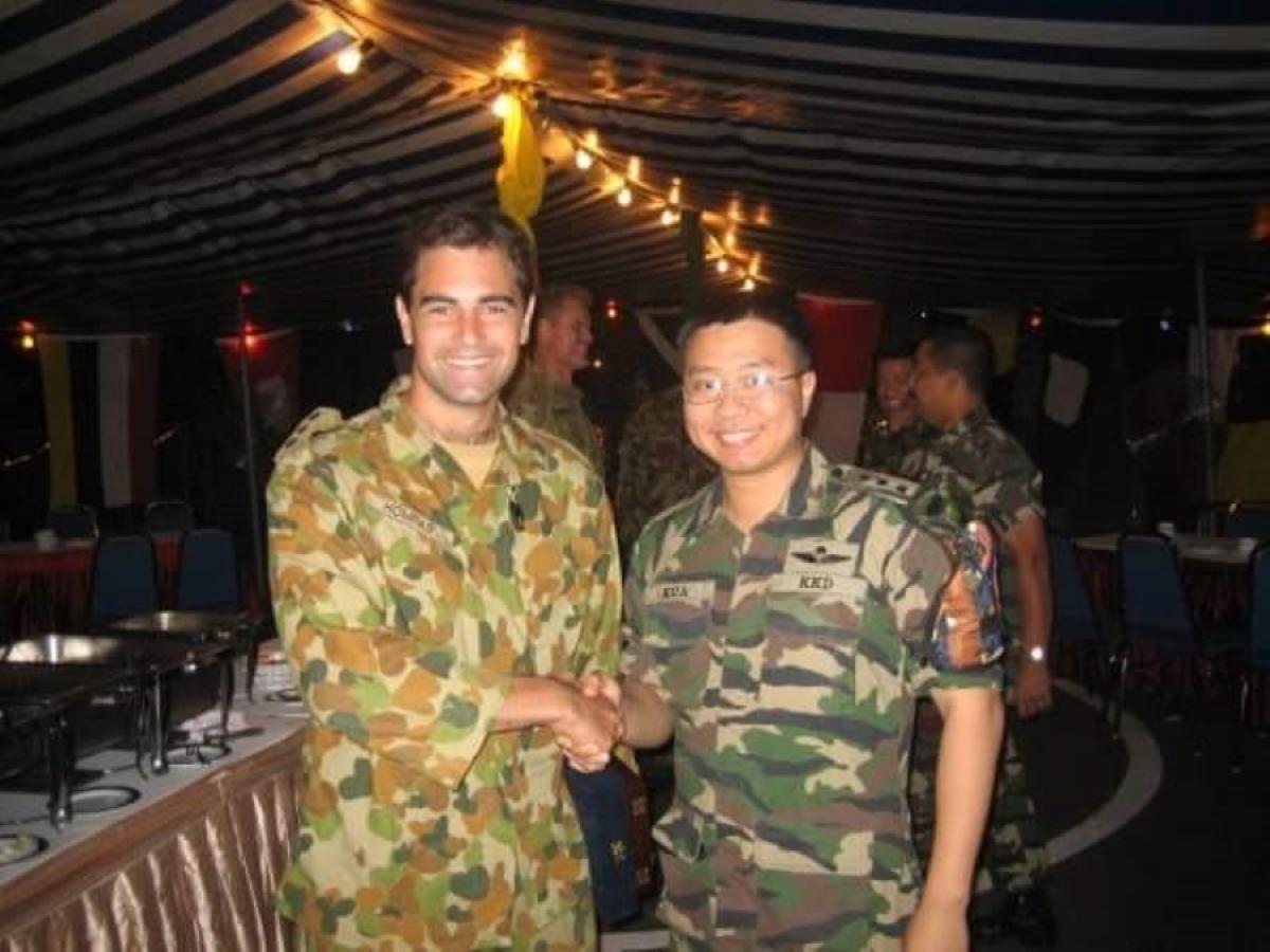 Dr Kua shakes hands with another soldier