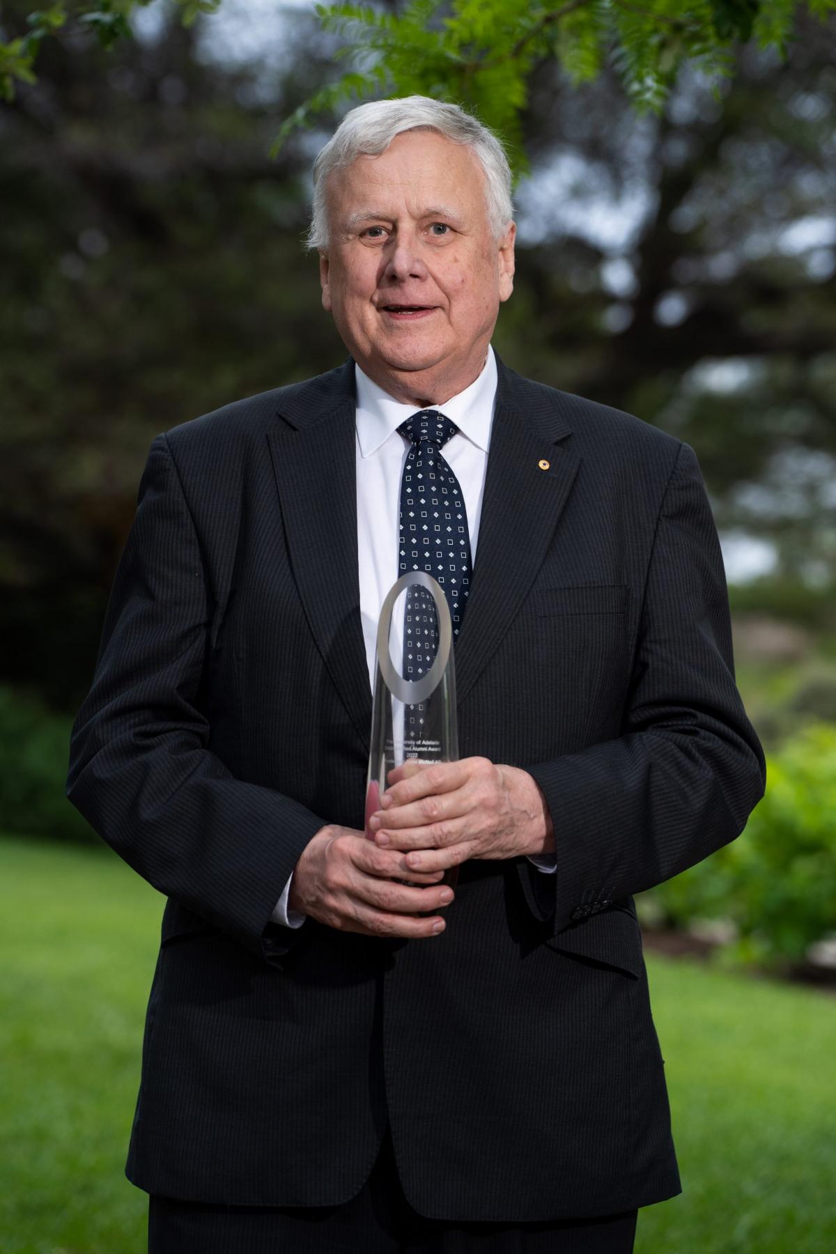 A portrait of John McNeil holding his DAA trophy