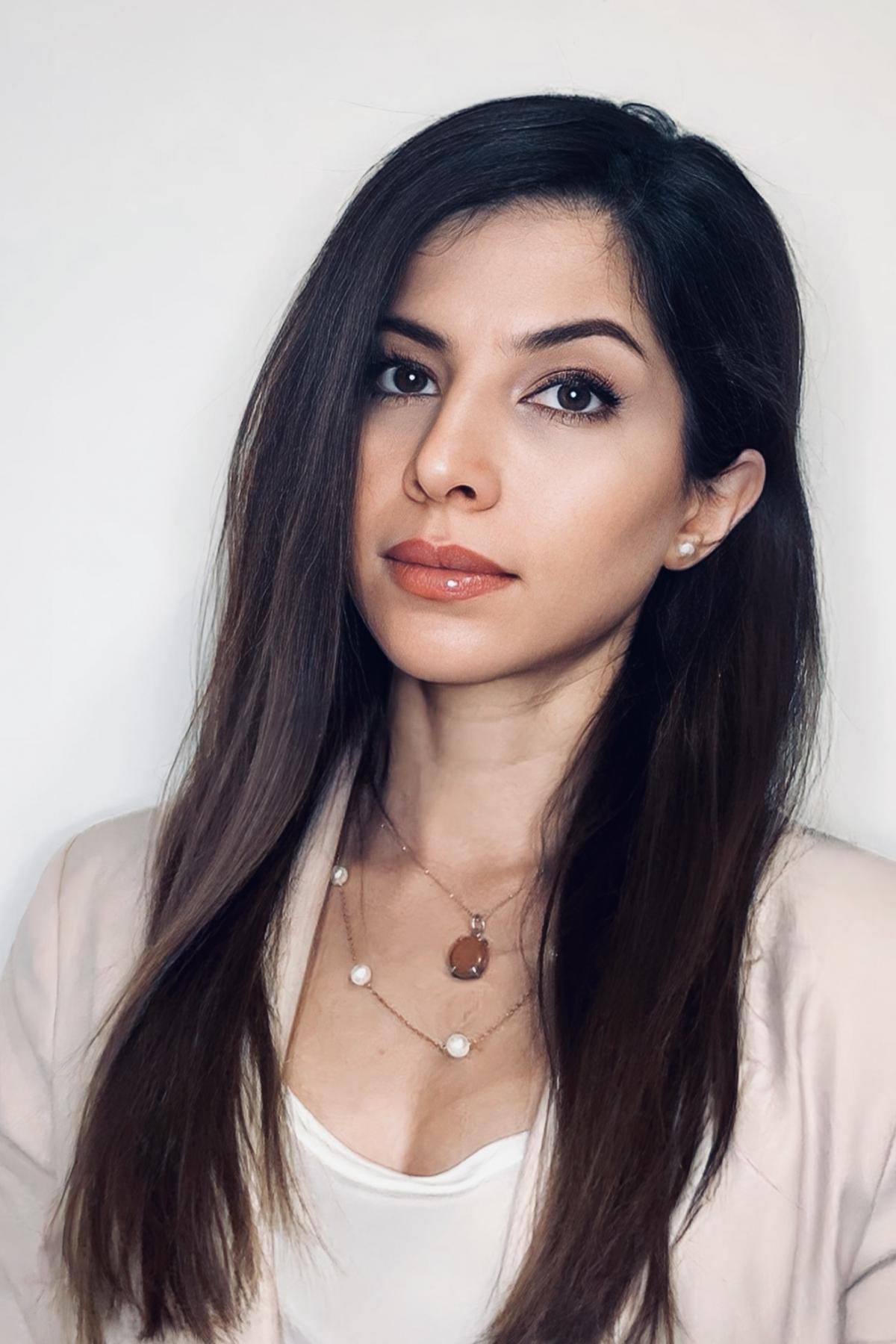 A portrait of Dr Desvarei in a beige blazer