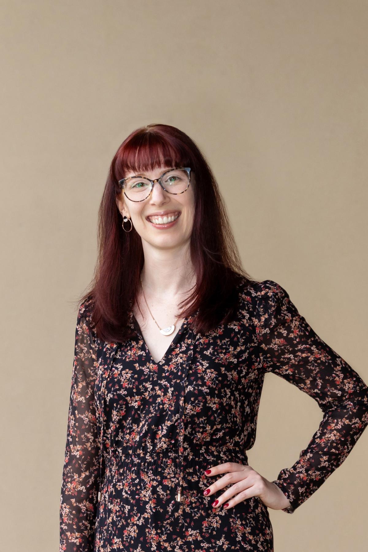 A portrait of Ashleigh Geiger smiling with hand on hip
