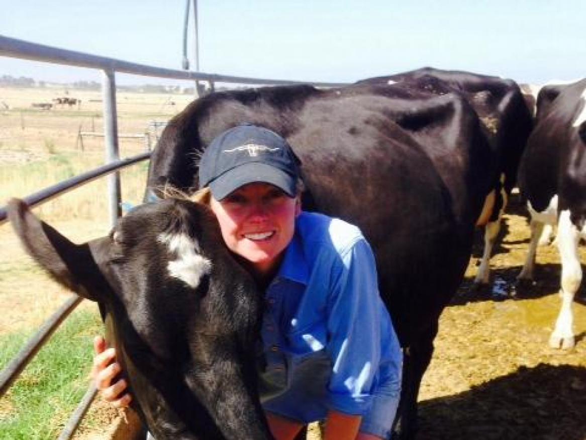 Image of Emma Goode with a cow