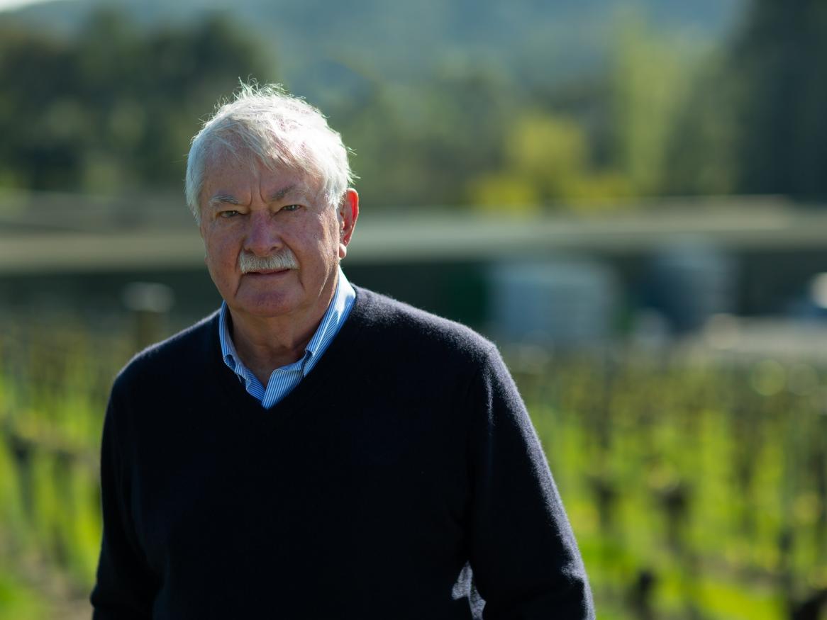 Dr Brian Croser AO stands in a vineyard