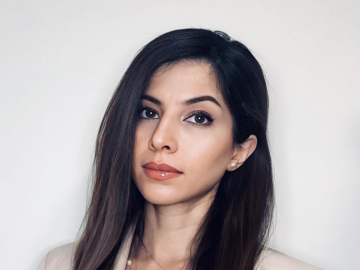A portrait of Dr Desvarei in a beige blazer