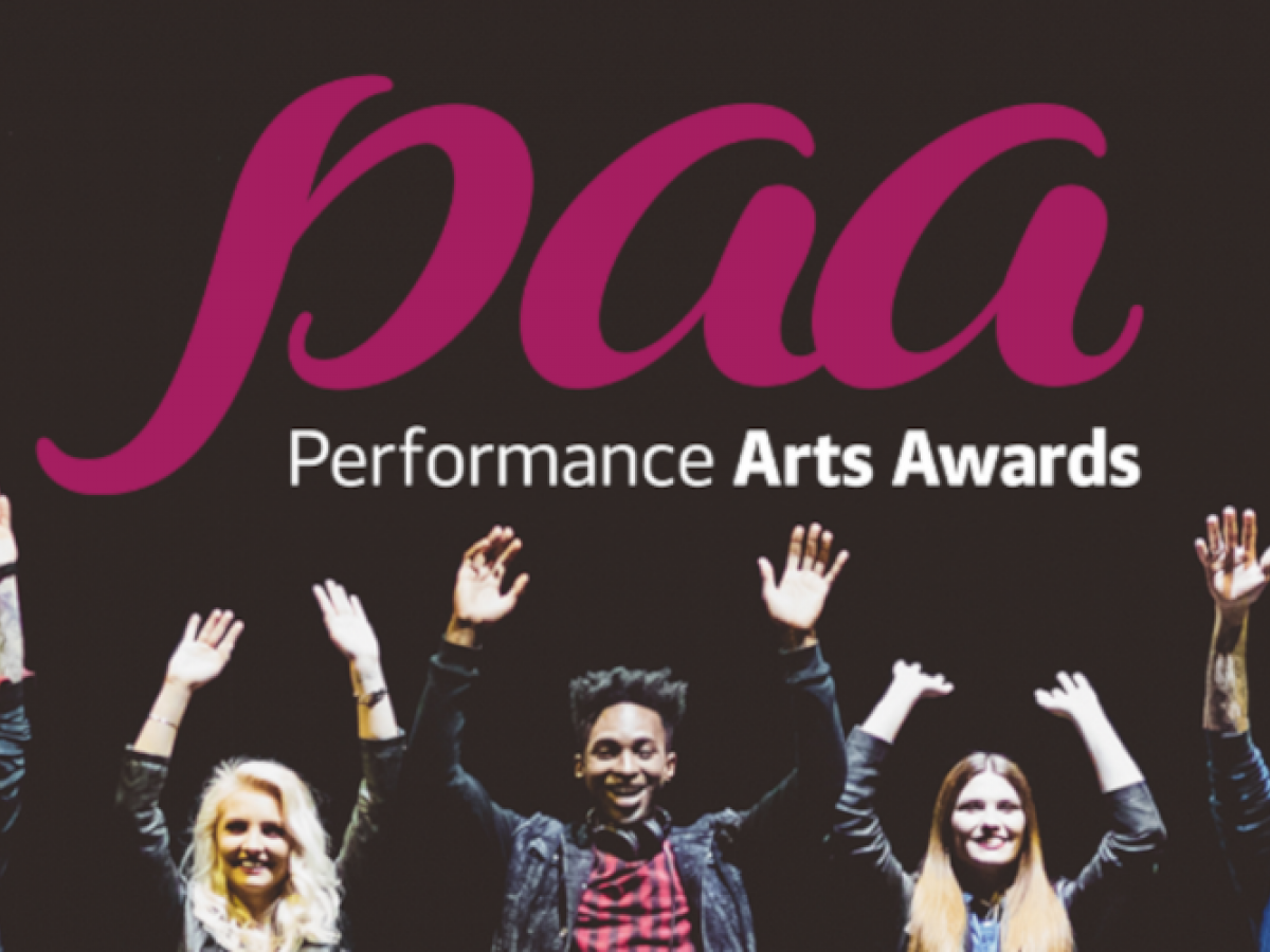 Actors about to take a bow on stage wit the paa logo above