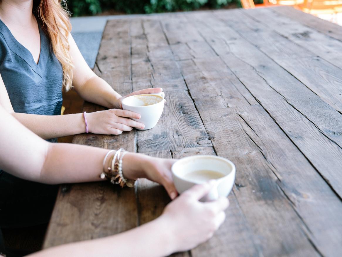 People chatting over coffee at a table