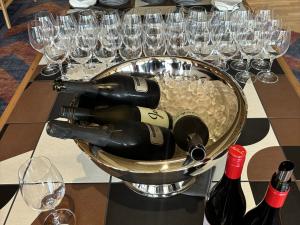 Wine bottles in cooler with glasses