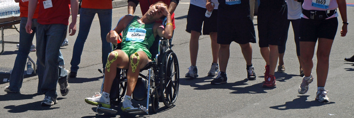 marathon runner finishing in wheelchair - image