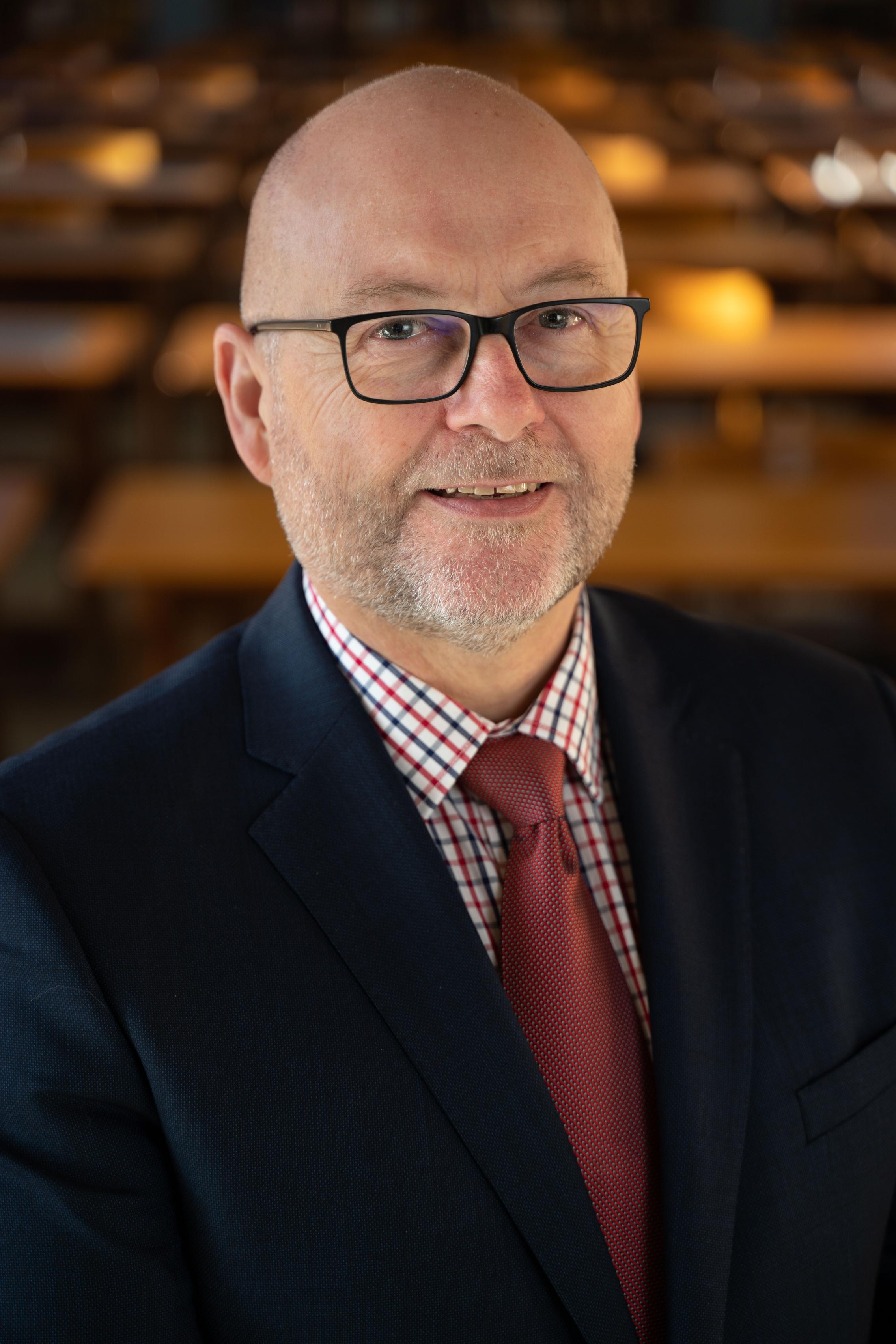 Image of Dave Lamb wearing a suit and tie.