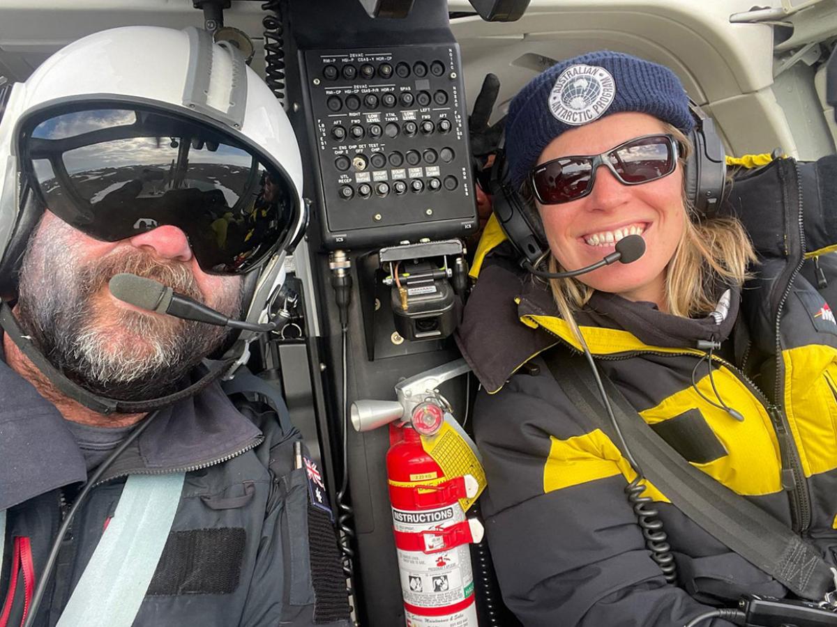 Dr Isabelle Onley (right) helicommuting in Antarctica