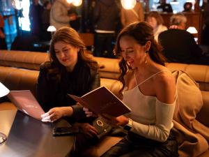 Two women looking at a menu