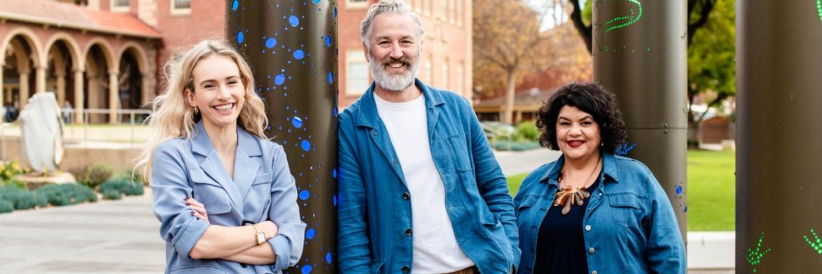 Isobel Marshall, Professor John Carty and Kirstie Parker stand in the Kaurna Learning Circle on the University's North Terrace campus