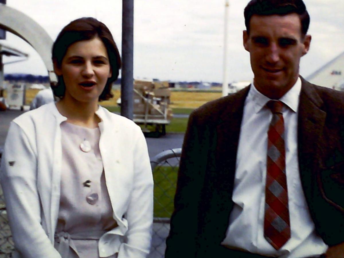Barbara and Ken Klaebe standing together outside in professional attire.