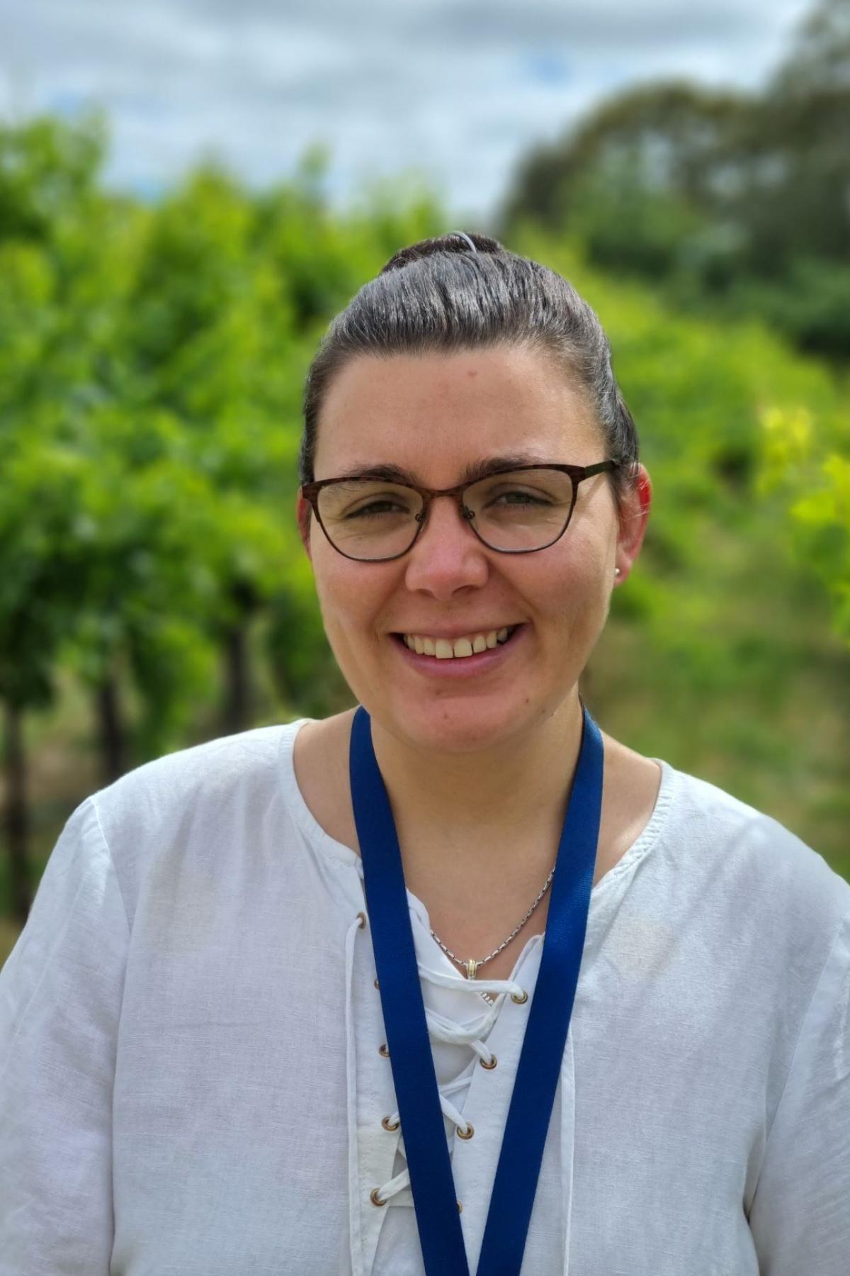 Image of female wine researcher standing in a vineyard