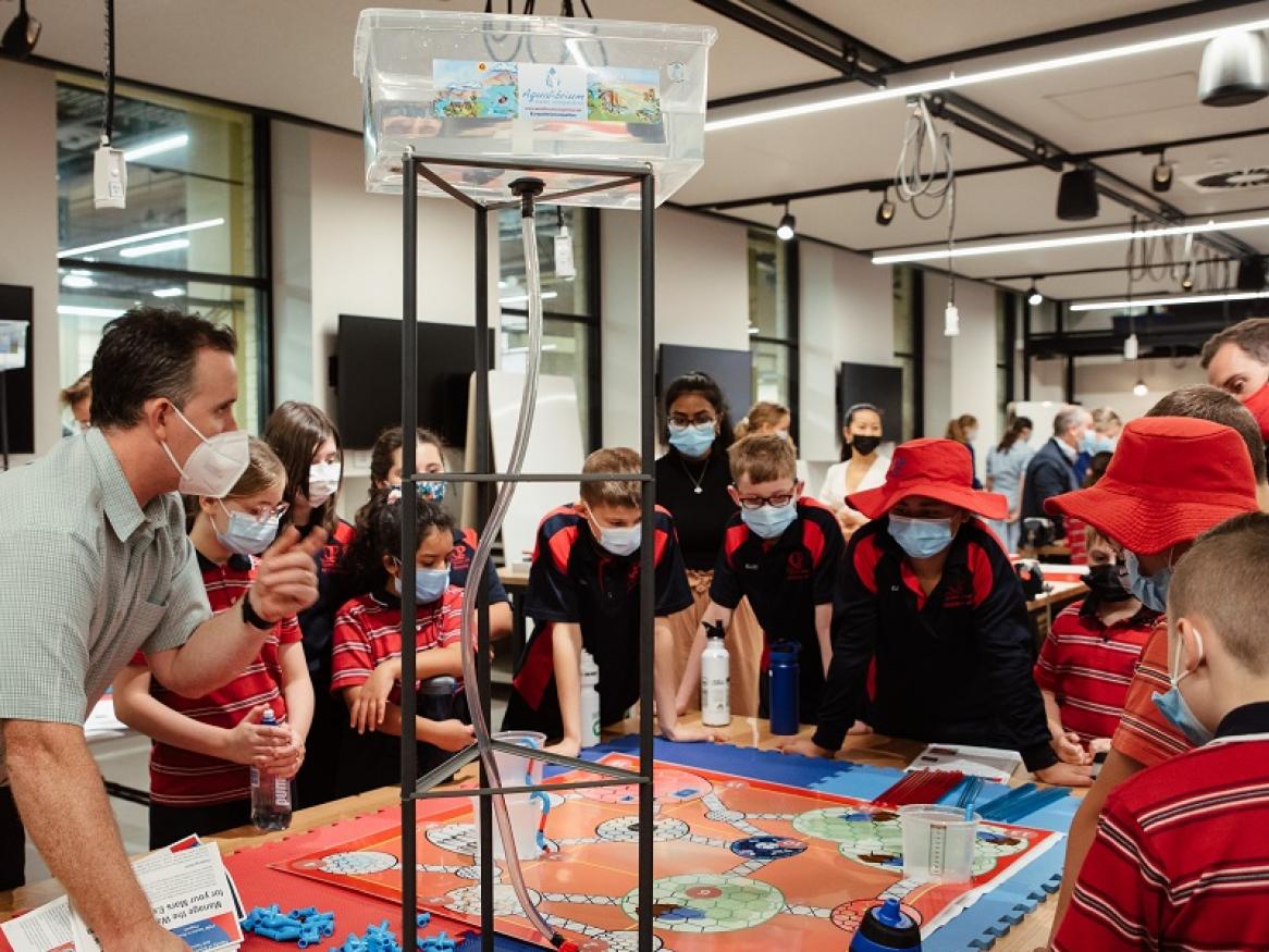 Dr Brendan Scott (School of Civil, Environmental & Mining Engineering) and Yashila Balakrishnan (AUCE President) explore off-world water management with students from Our Lady Queen of Peace School. 