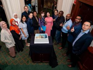 Students celebrating with cake at the University of Adelaide Sponsored Students Farewell Event