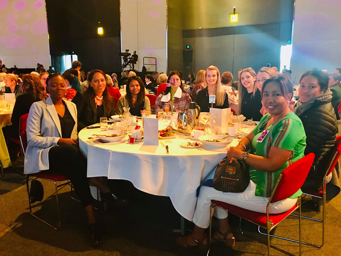 Group photo of attendees at UN International Women's Day breakfast.
