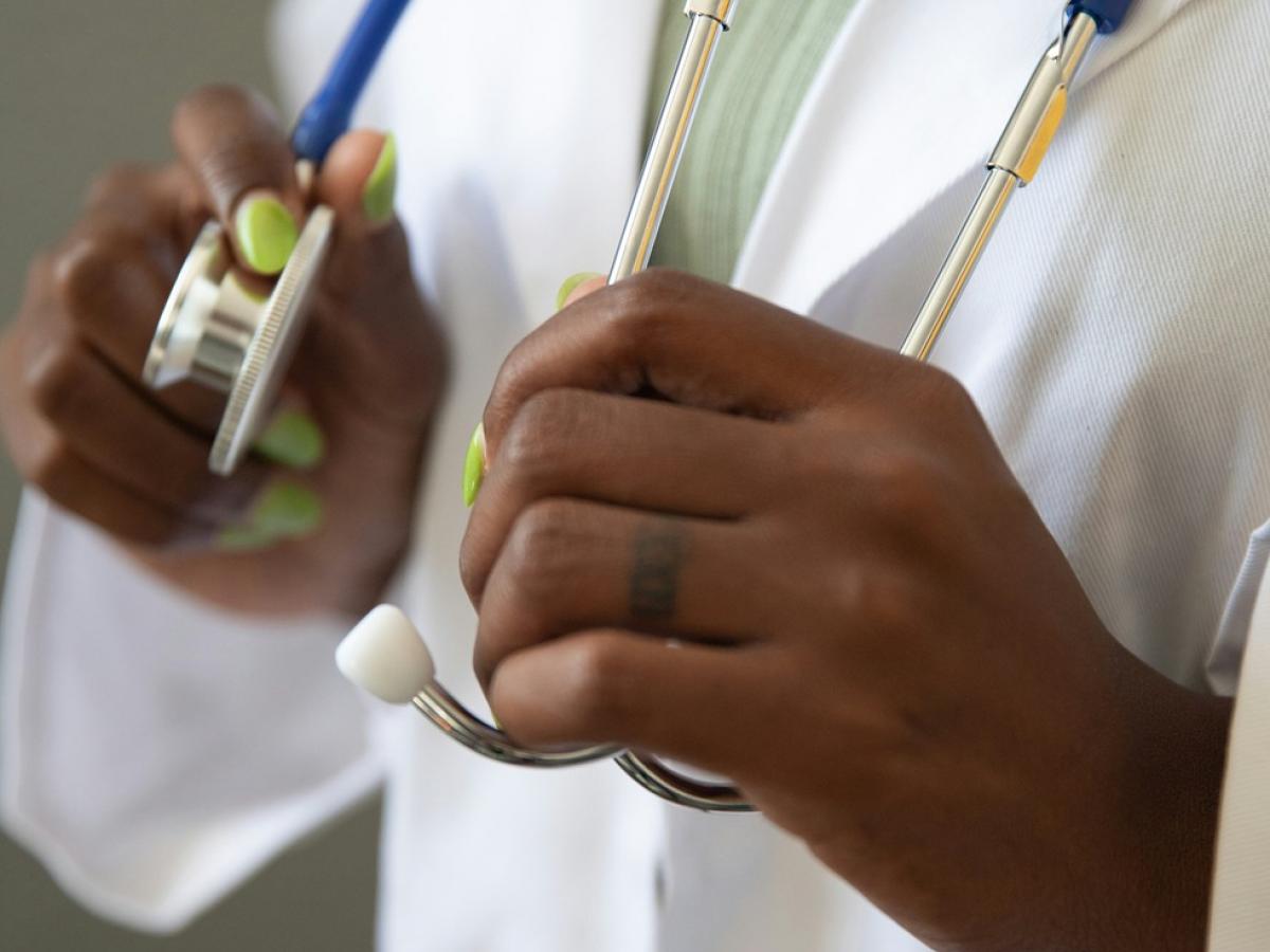 Healthcare practitioner holding a stethoscope