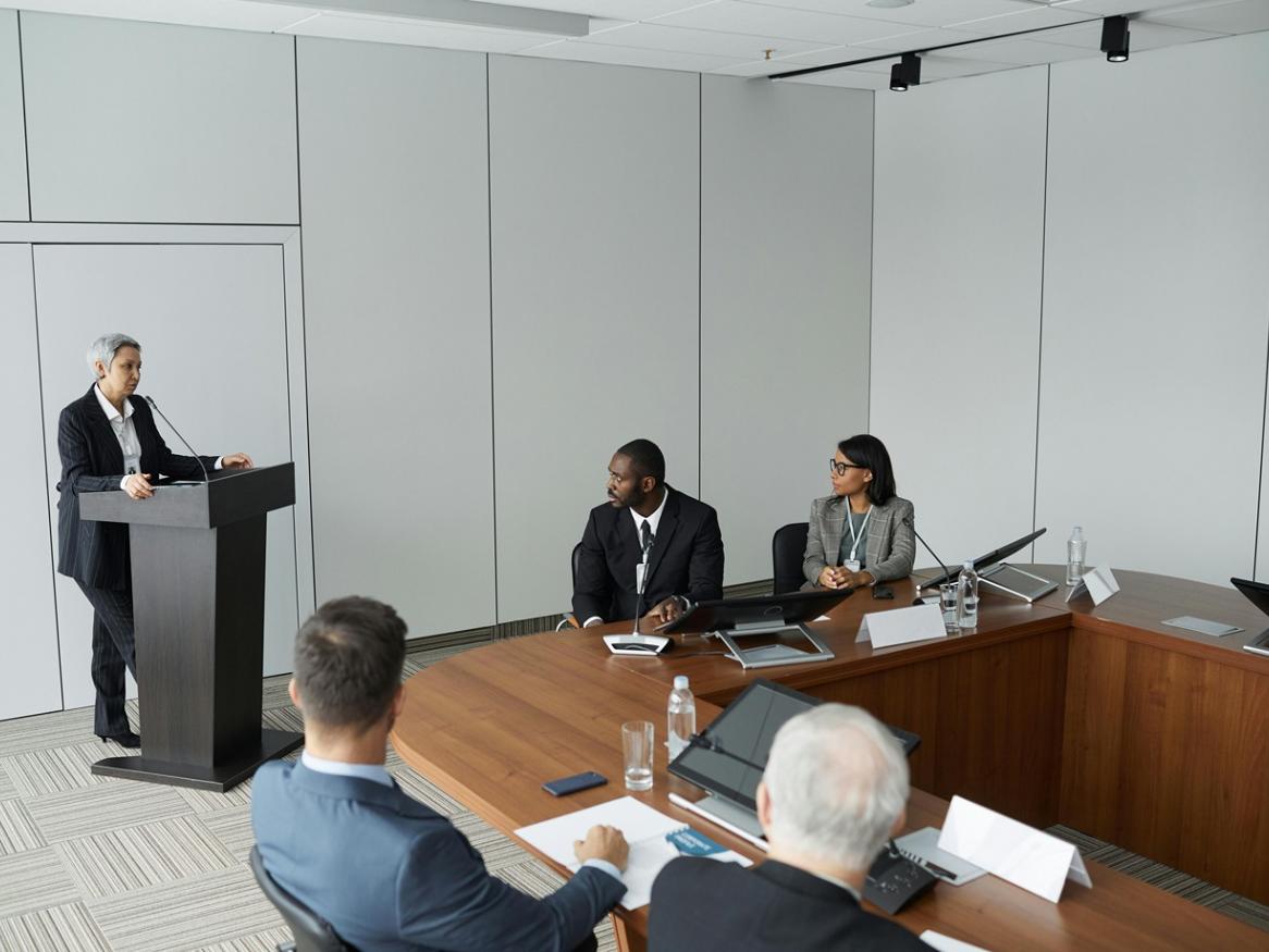 People conversing in a boardroom