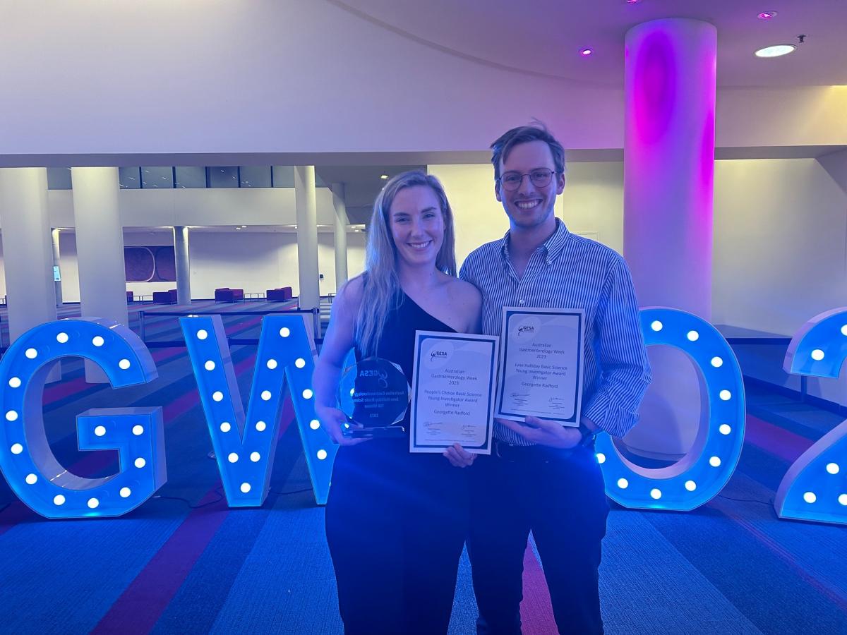 Georgette standing next to friend holding awards