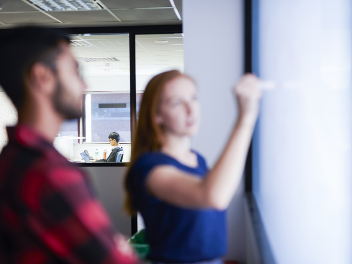 Two students looking at a screen