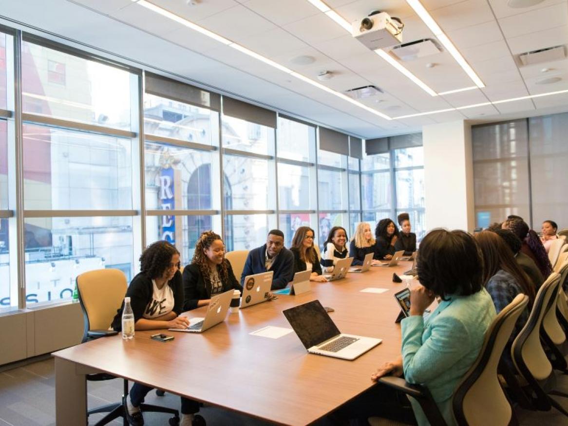 Group of people sitting around a conference table