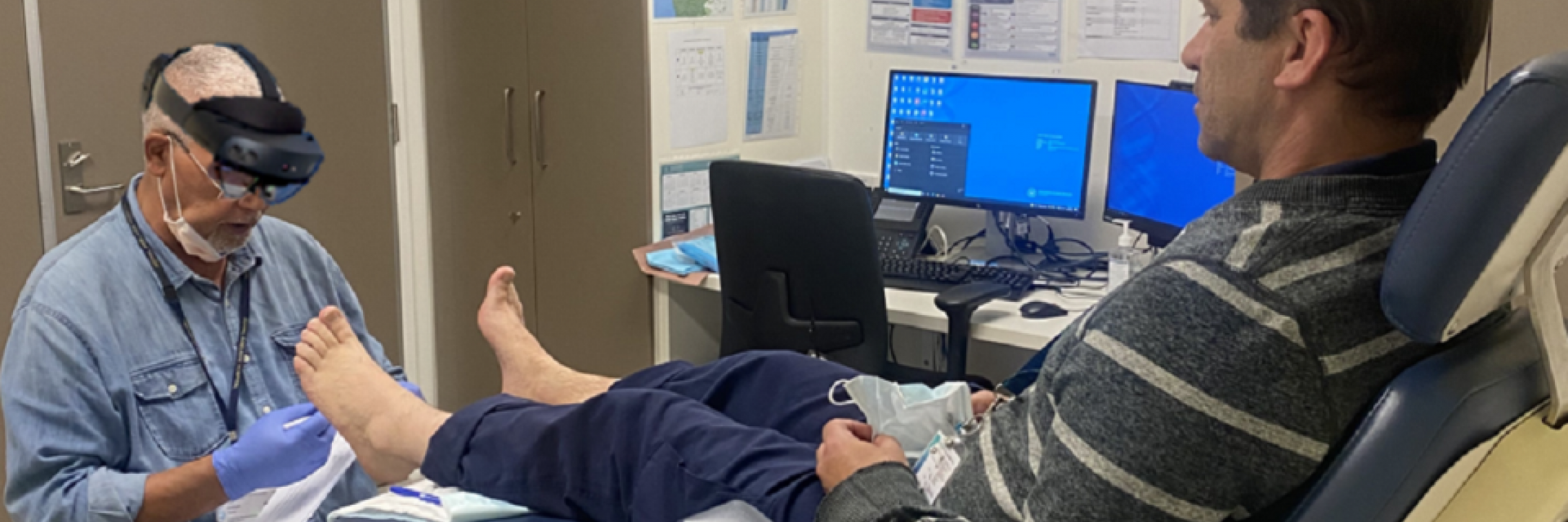doctor with MR glasses diagnosing foot condition