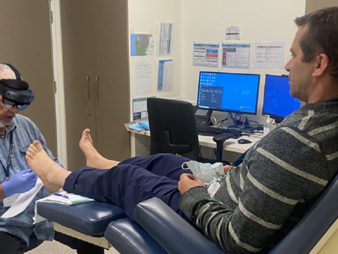 doctor with MR glasses diagnosing foot condition