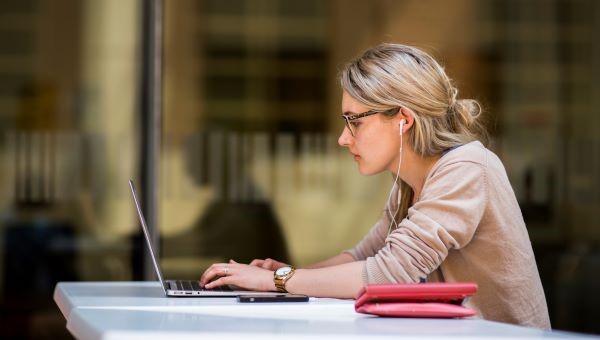 Female student studying outside with laptop